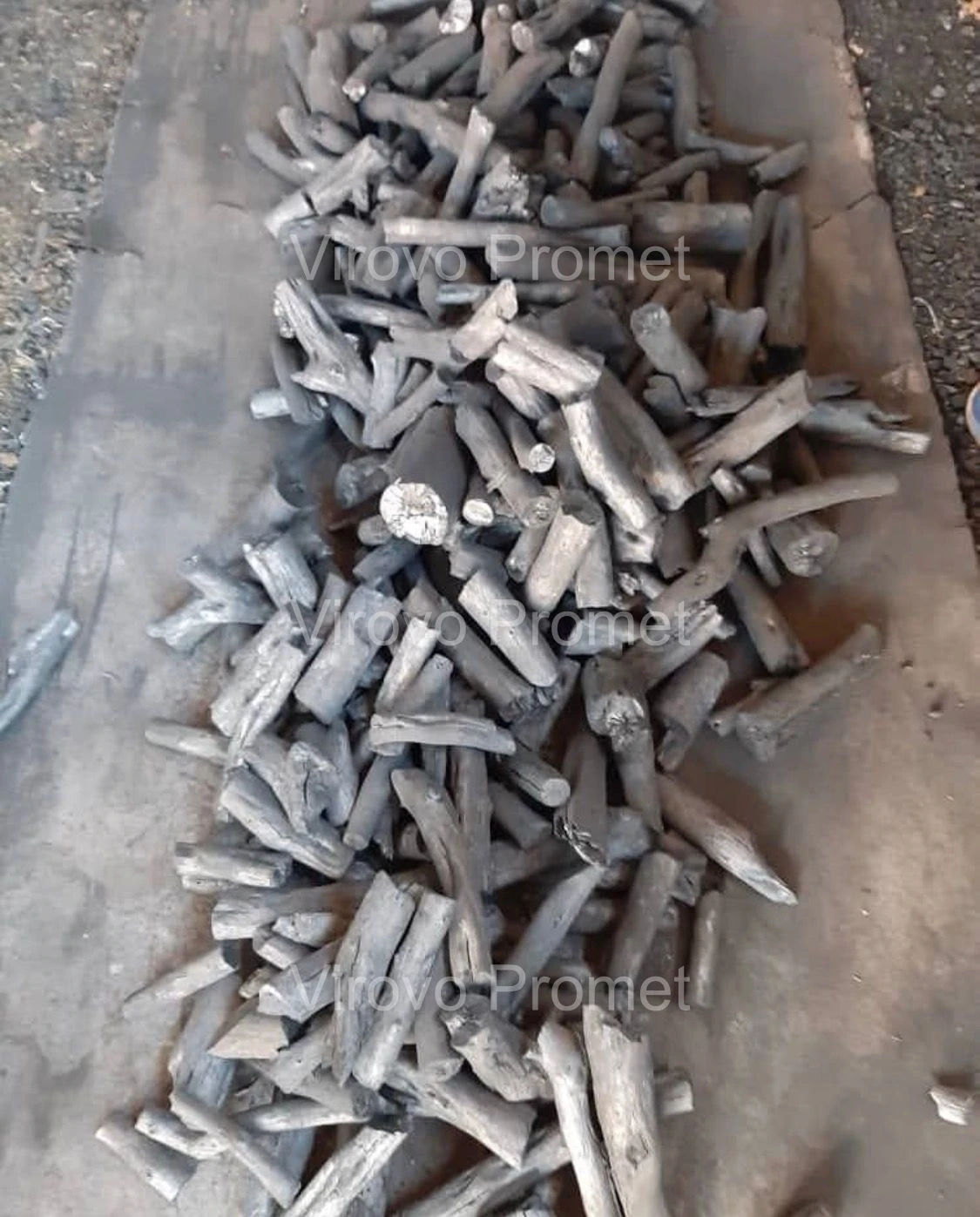 Marabu charcoal — long, dense pieces spread out on the floor