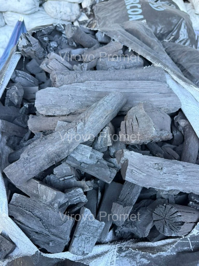 Oak charcoal — long pieces and chunks in an opened sack
