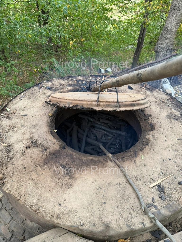 Charcoal visible inside an open kiln