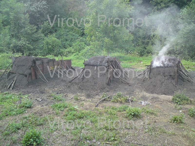 Traditional earthen charcoal kilns slowly smoking